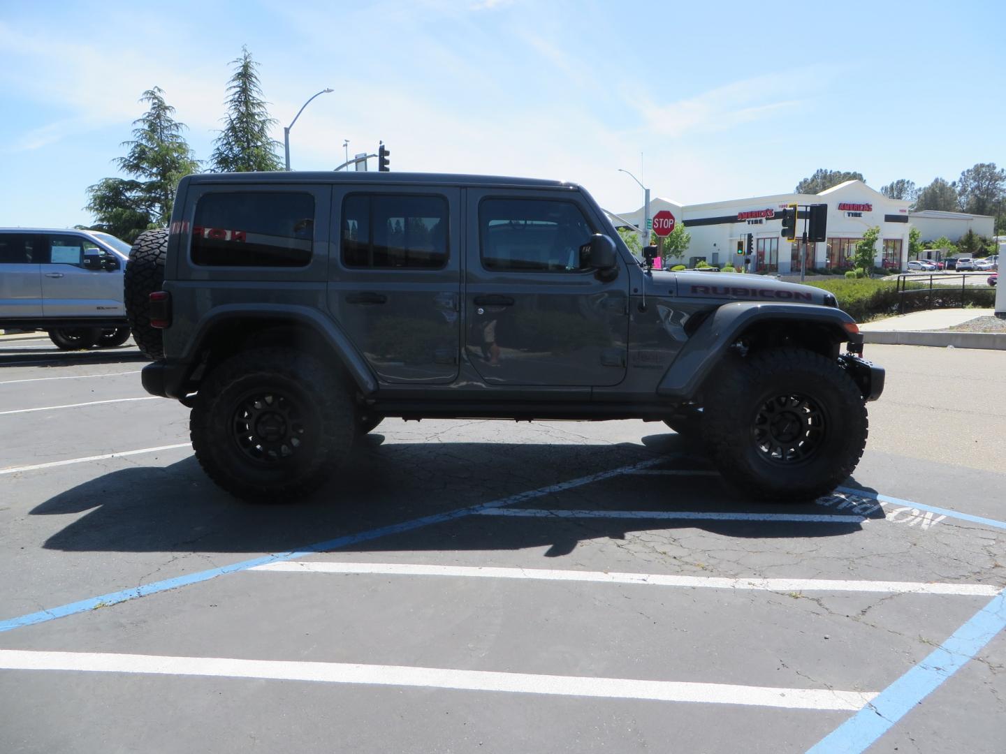 2021 Sting Grey /BLACK Jeep Wrangler Unlimited Rubicon (1C4JJXFM5MW) with an 3.0L V6 DOHC 24V TURBO DIESEL engine, 6A transmission, located at 2630 Grass Valley Highway, Auburn, CA, 95603, (530) 508-5100, 38.937893, -121.095482 - Diesel JL with Sky One power top featuring a Teraflex suspension system, Falcon adjustable shocks & steering stabilizer, Full Metal Cloak skid plate, 17" Method bead grip wheels, 37" Toyo RT Trail tires, Warn winch, Rigid Led lighting, Teraflex HD spare tire carrier, Teraflex Diff covers, Amp steps, - Photo#3